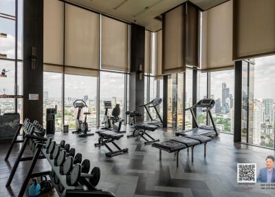 Spacious high-rise gym with a city view