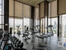 Spacious high-rise gym with a city view