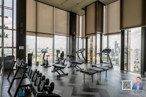 Spacious high-rise gym with a city view