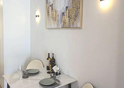 Modern dining area with artwork and lighting