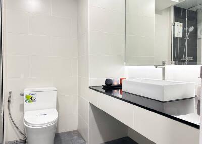 Modern bathroom with sleek vanity and toilet