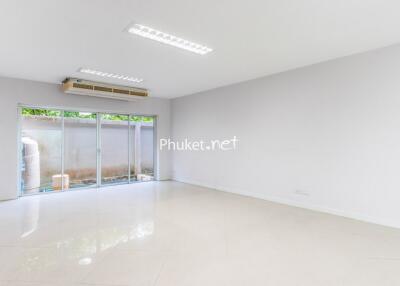 Empty living room with large sliding glass doors and air conditioning