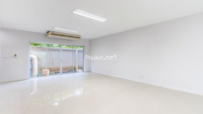 Empty living room with large sliding glass doors and air conditioning