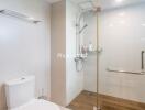 Clean and modern bathroom with glass shower and toilet