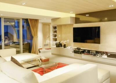 Modern living room with large TV and comfortable seating