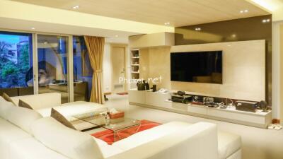 Modern living room with large TV and comfortable seating