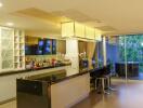 Modern kitchen with bar counter and large glass doors