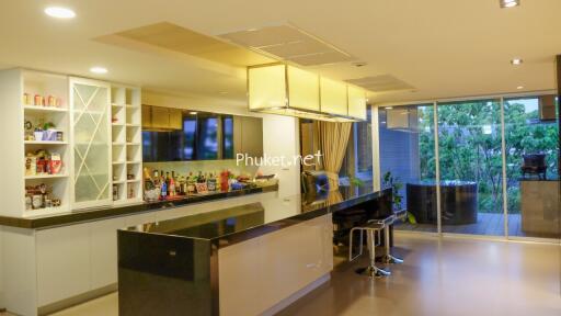 Modern kitchen with bar counter and large glass doors