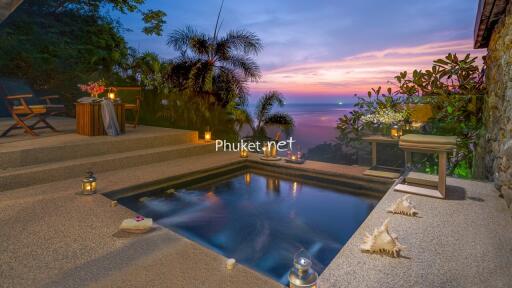 Beautiful outdoor area featuring a small pool with a view of the ocean at sunset