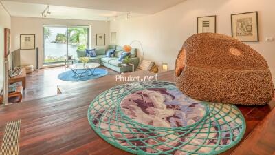 Spacious living room with modern furniture and view of the water