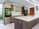 Modern kitchen with island counter and built-in appliances