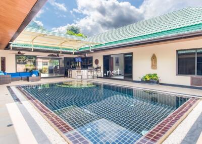 Outdoor area with swimming pool and patio seating