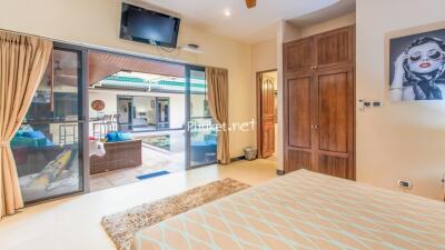 Stylish bedroom with large glass doors opening to a patio