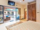 Stylish bedroom with large glass doors opening to a patio