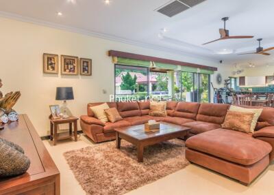Spacious living room with a large sectional sofa, ceiling fans, and open layout