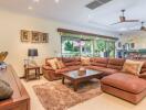 Spacious living room with a large sectional sofa, ceiling fans, and open layout