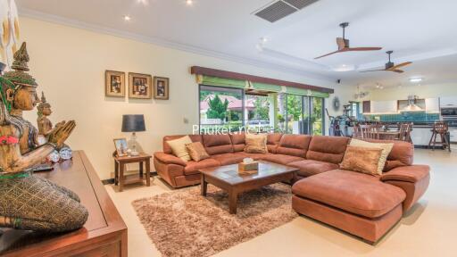 Spacious living room with a large sectional sofa, ceiling fans, and open layout