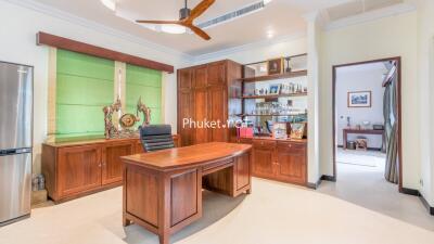 Well-lit home office with wooden furniture and shelving