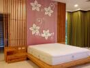 Bedroom with wooden accents and floral wall design