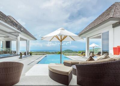 Outdoor seating area by the pool with ocean view