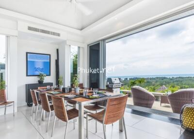 Modern dining area with large windows and ocean view