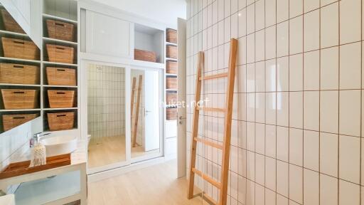 Modern bathroom with storage units and ladder rack