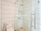 Modern white tile bathroom with shower and toilet