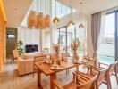 Open living room with dining area featuring large windows and pool view