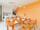 Stylish dining room with wooden furniture and accent wall