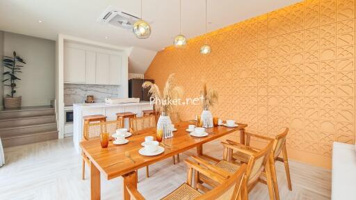 Stylish dining room with wooden furniture and accent wall