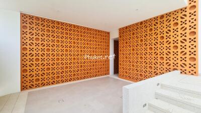 Modern building entrance with decorative wall and stairs