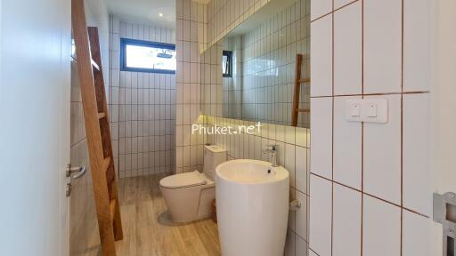 Modern bathroom with white tiles and wooden accents