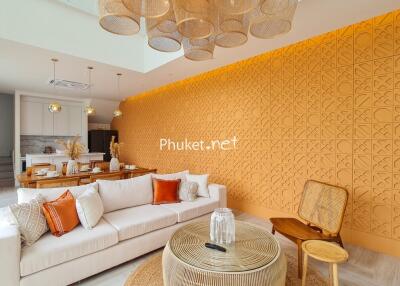 Modern living room with orange accent wall and decorative lighting