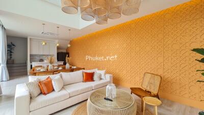 Modern living room with orange accent wall and decorative lighting