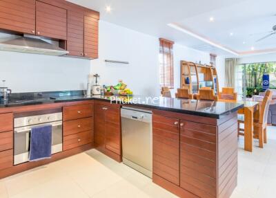 Modern kitchen with wooden cabinetry and dining area