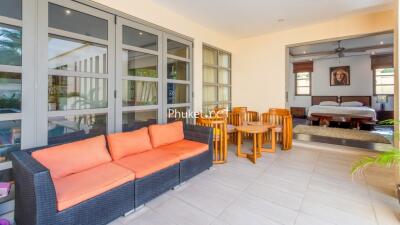 Spacious living area with seating and adjacent bedroom