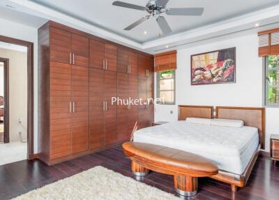 Spacious bedroom with modern furniture and large wardrobe