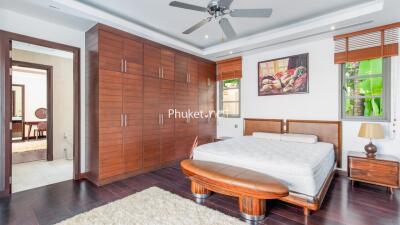 Spacious bedroom with modern furniture and large wardrobe