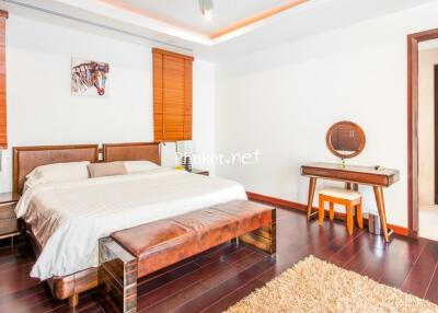 Spacious bedroom with wooden furniture and en-suite bathroom