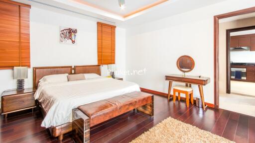 Spacious bedroom with wooden furniture and en-suite bathroom