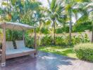 A lush backyard with a covered seating area