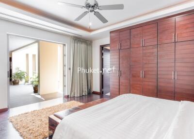 Spacious modern bedroom with large wardrobe and balcony access