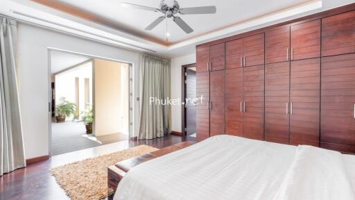 Spacious modern bedroom with large wardrobe and balcony access