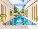 Modern outdoor pool area with palm trees and blue sky