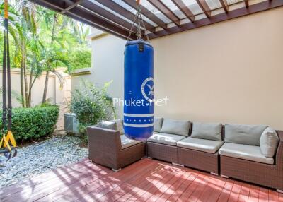 Outdoor patio with punching bag and comfortable seating