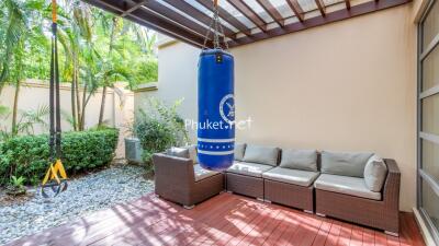 Outdoor patio with punching bag and comfortable seating