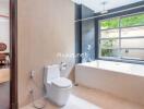 Modern bathroom with a large bathtub and a view of the garden