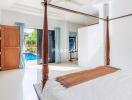 Bedroom with a canopy bed and view of the pool through glass doors