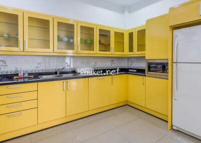 Modern kitchen with yellow cabinets and appliances