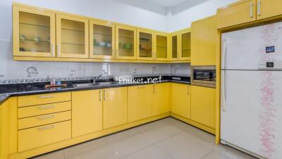 Modern kitchen with yellow cabinets and appliances